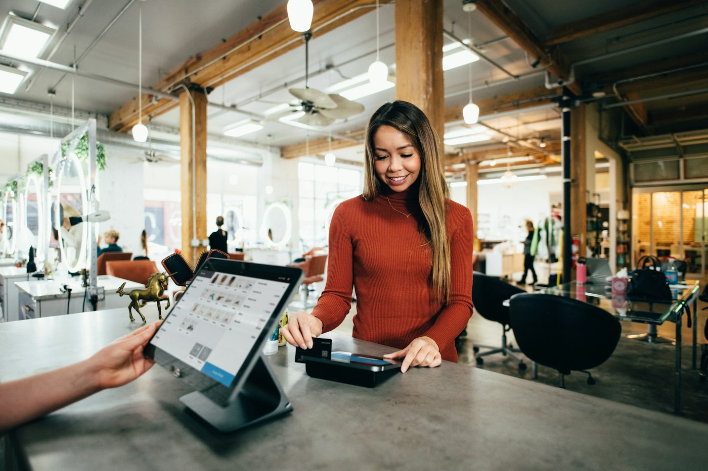 A business owner taking a card payment at a counter